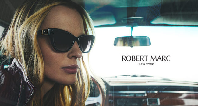 Woman wearing Robert Marc sunglasses sitting in a car